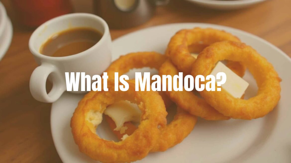 Golden-brown deep-fried mandoca cornmeal rings on a plate, crispy outside and soft inside, with melted cheese bits, served warm with butter and a cup of coffee, traditional Venezuelan breakfast, cozy and inviting.