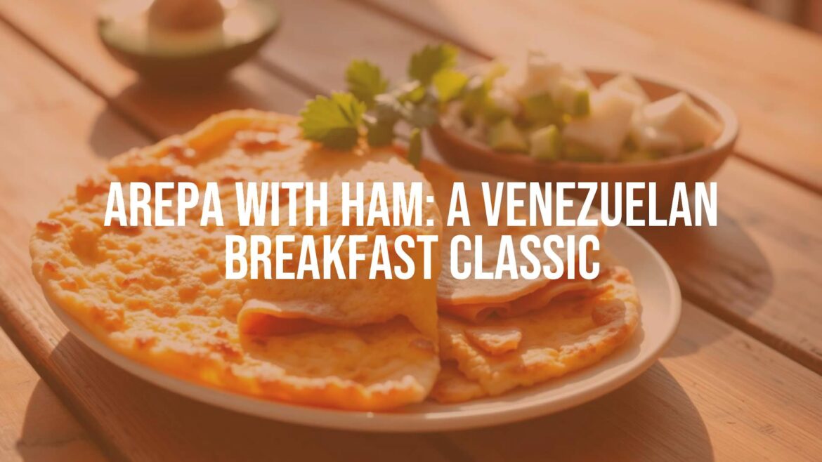 A golden-brown Venezuelan arepa split open and filled with slices of ham, served on a rustic wooden table with a side of fresh avocado and cheese, warm morning sunlight.